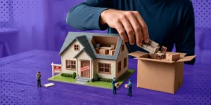Representación metafórica de un embargo de bienes con una mano retirando muebles de una maqueta de casa para guardarlos en una caja.